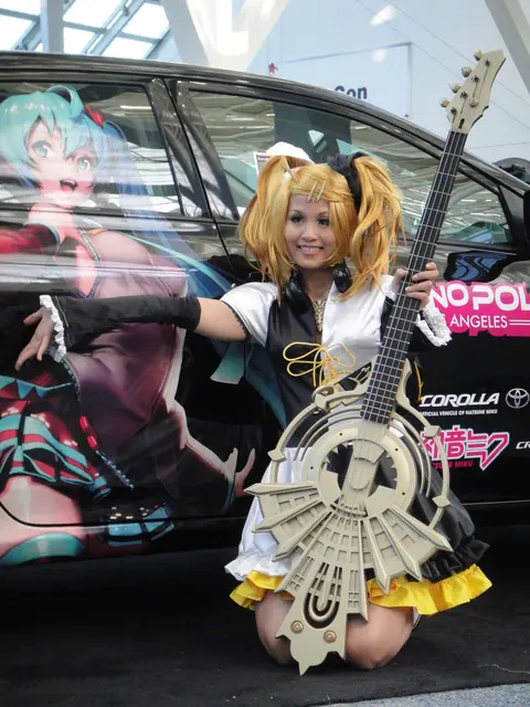 Cosplayer of Kagamine Rin and itasha of Hatsune Miku at Anime Expo 20110701